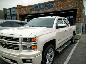 Chevy Silverado parked in front of Pinthouse Pizza Chevy Loves Local